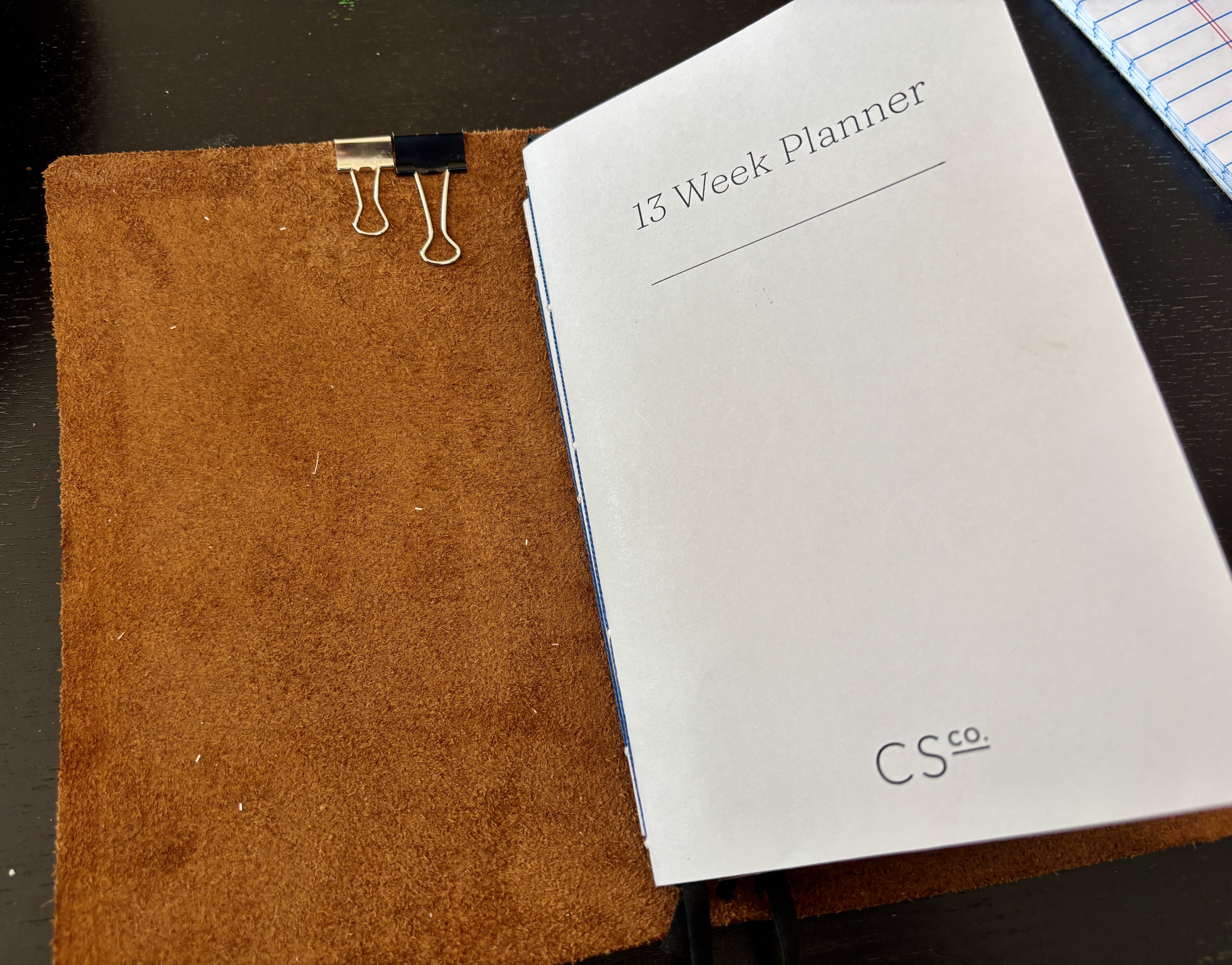 The leather notebook cover open to the first notebook, a "13 Week Planner".