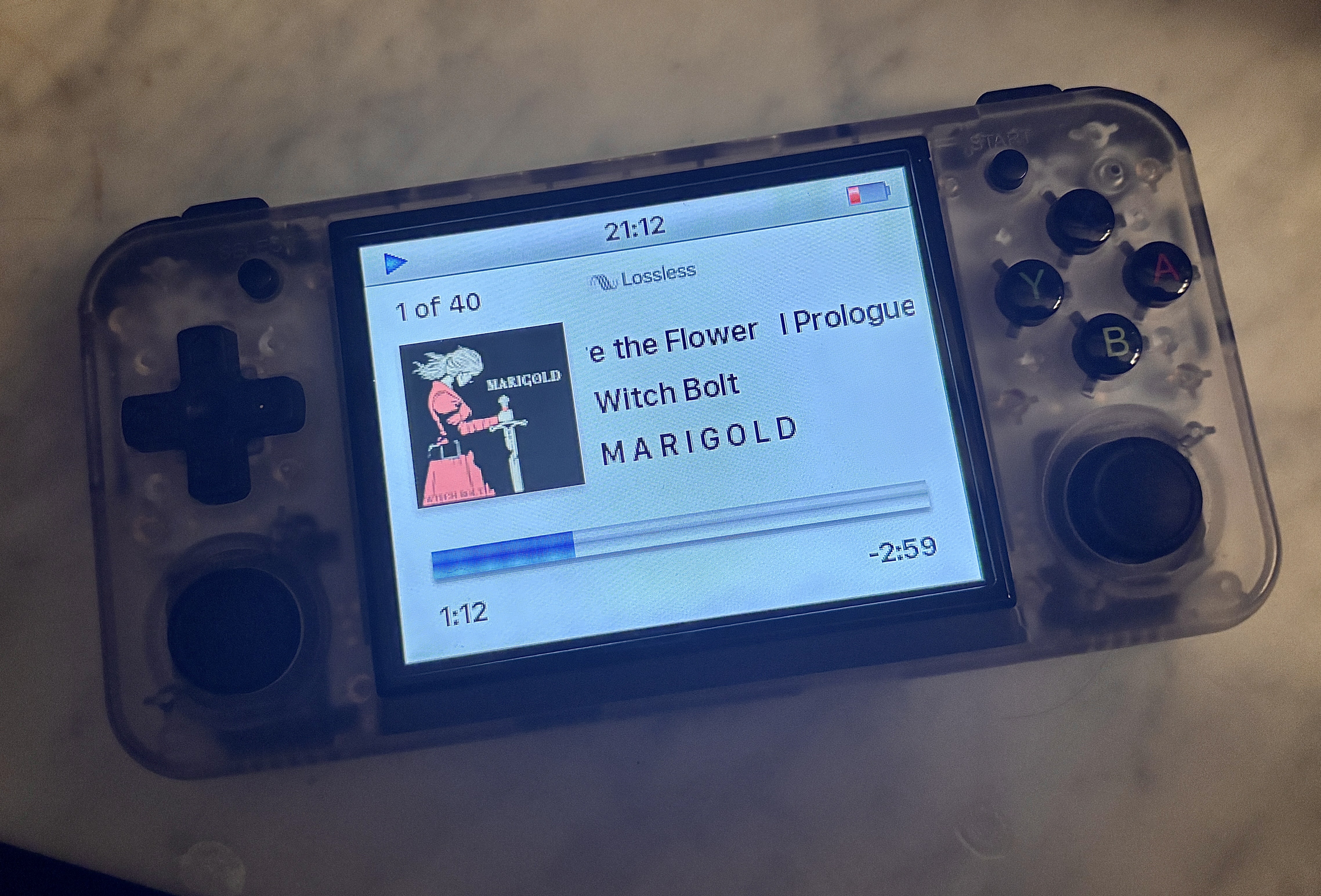 My Anbernic RG35XX H handheld emulator running RockBox with theme to match the old iPod Video. Currently playing _I Prologue: The Roots Before the Flower_ from Witch Bolt's _Marigold_ album.